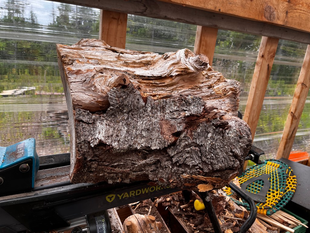 A very large piece of wood on a splitter